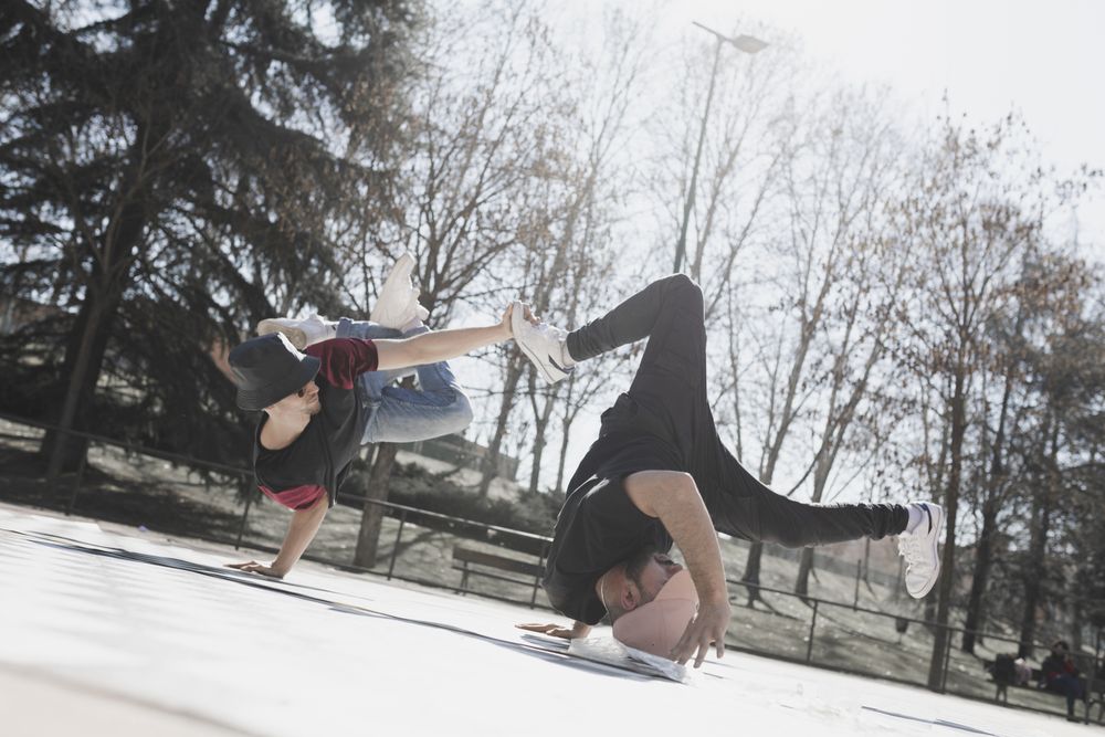 Young men dancing break dance in park