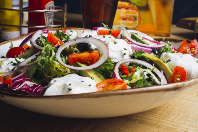 Vegetables salad with onion greens and cream sauce