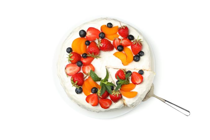 Plate with berry cream cake isolated on plain background