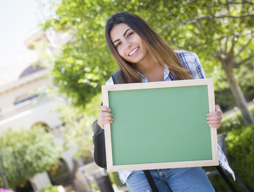 Female Student Holding Blank Green Chalkboard