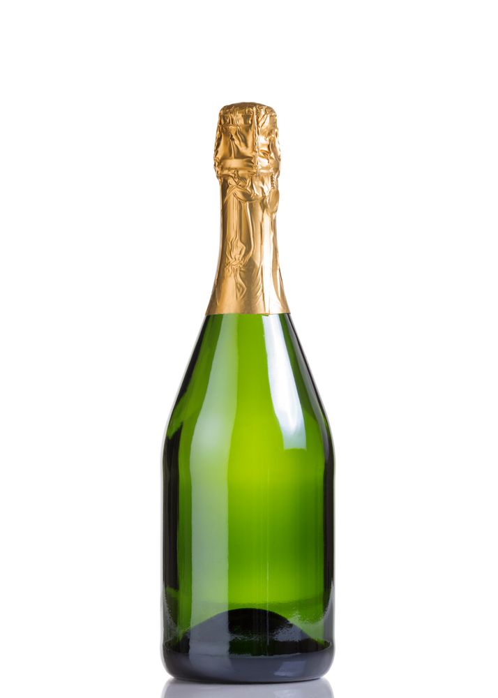 Unopened bottle of champagne isolated on plain background