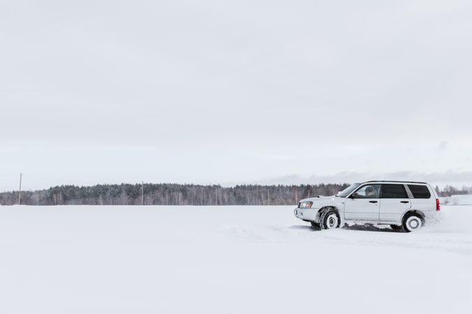 Car driving on snow field