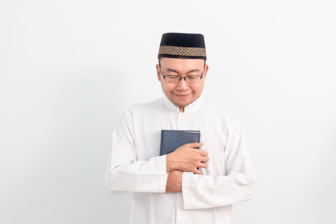 Asian Muslim man holding quran during Ramadan