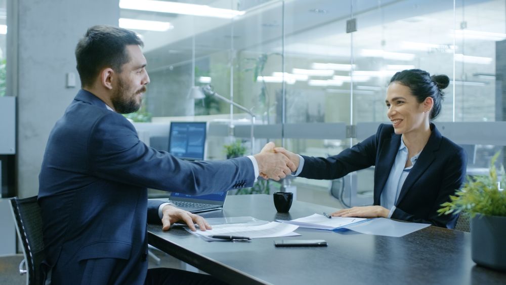 Businesswoman and Businessman Shake Hands.
