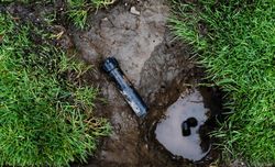 Sprinkler repairs with parts on ground