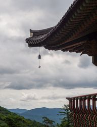 Roof of pagoda against cloudy sky