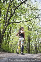 Rear view of woman in athletic gear in the forest 4dMJNb