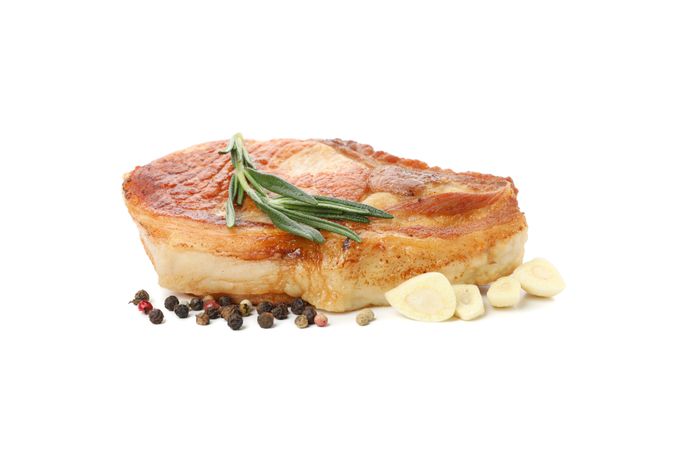 Fried pork steak isolated on light background. Grilled food