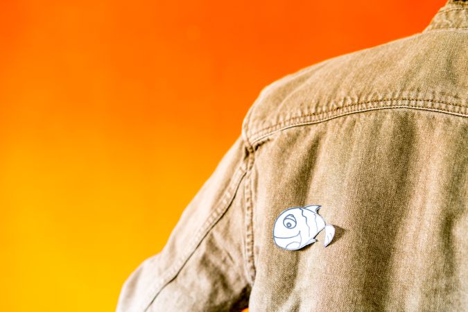 man with funny paper toy on jean jacket