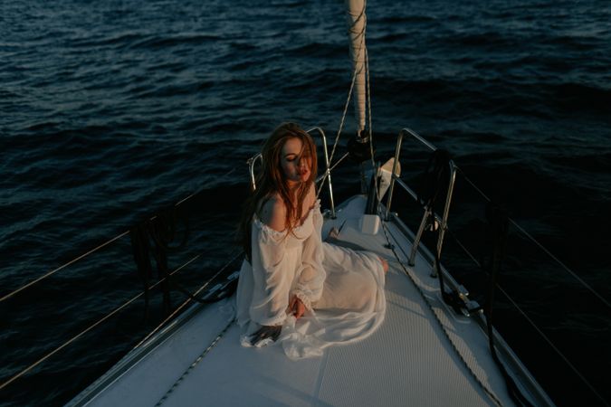 Woman in luxury dress resting on yacht
