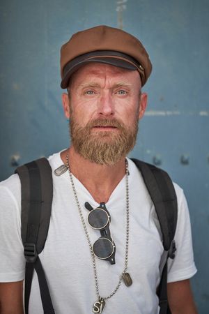 Serious mature traveling man in stylish cap