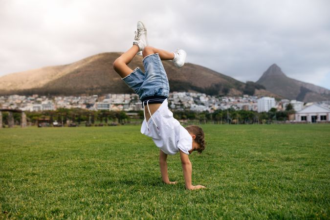 Boy playing acrobatically in a ground