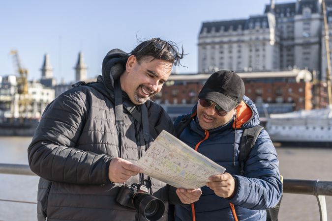 Travelers reading a map, LGBT couple