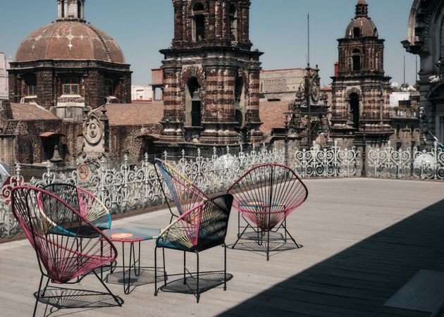 Seats on rooftop next to historic building in Mexican capital