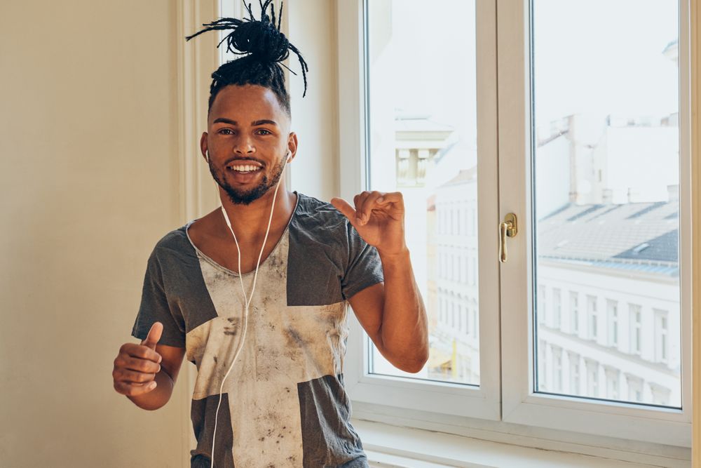 Cheerful Black male listening to music