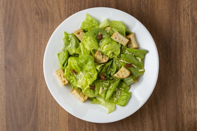 Caesar salad with croutons and bacon.