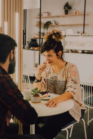 Delighted woman enjoying dessert in cafe