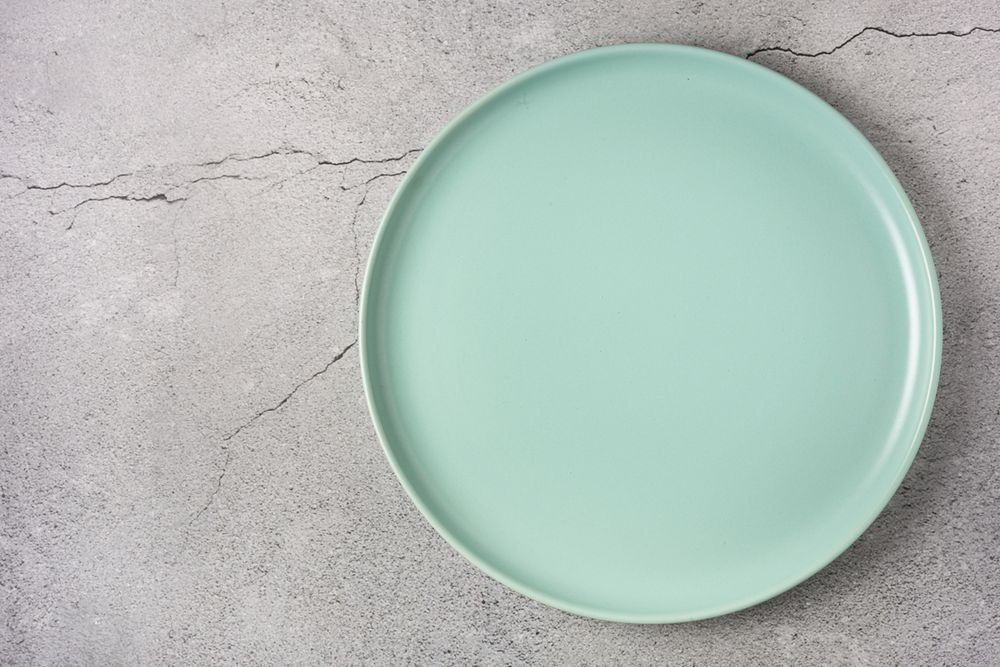 Empty plate on the slate table. Top view of the image.