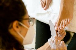 Toe nails being filed in professional spa