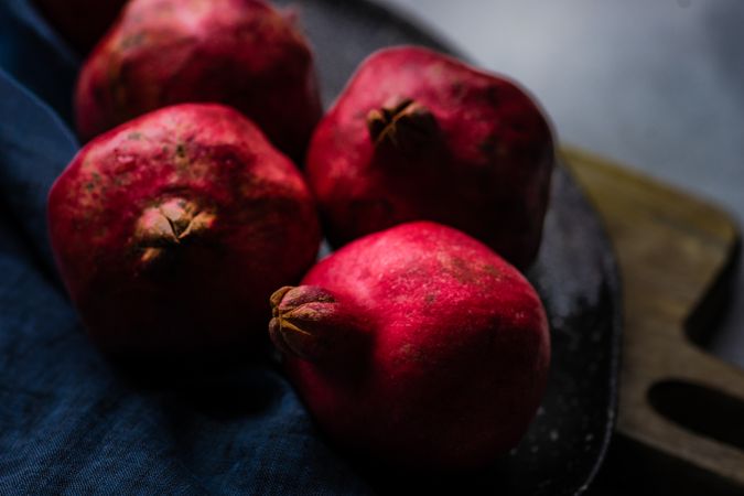 Whole pomegranate on breadboard