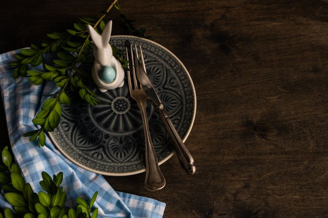 Spring table setting with rabbit figurine and foliage