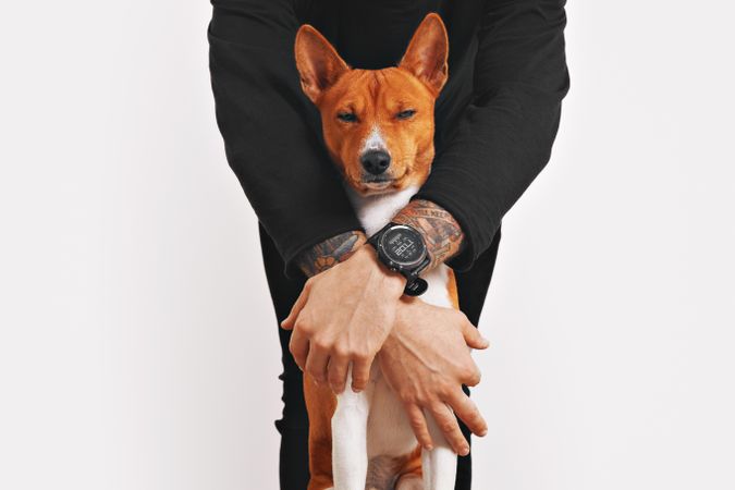 Man with arms around dog