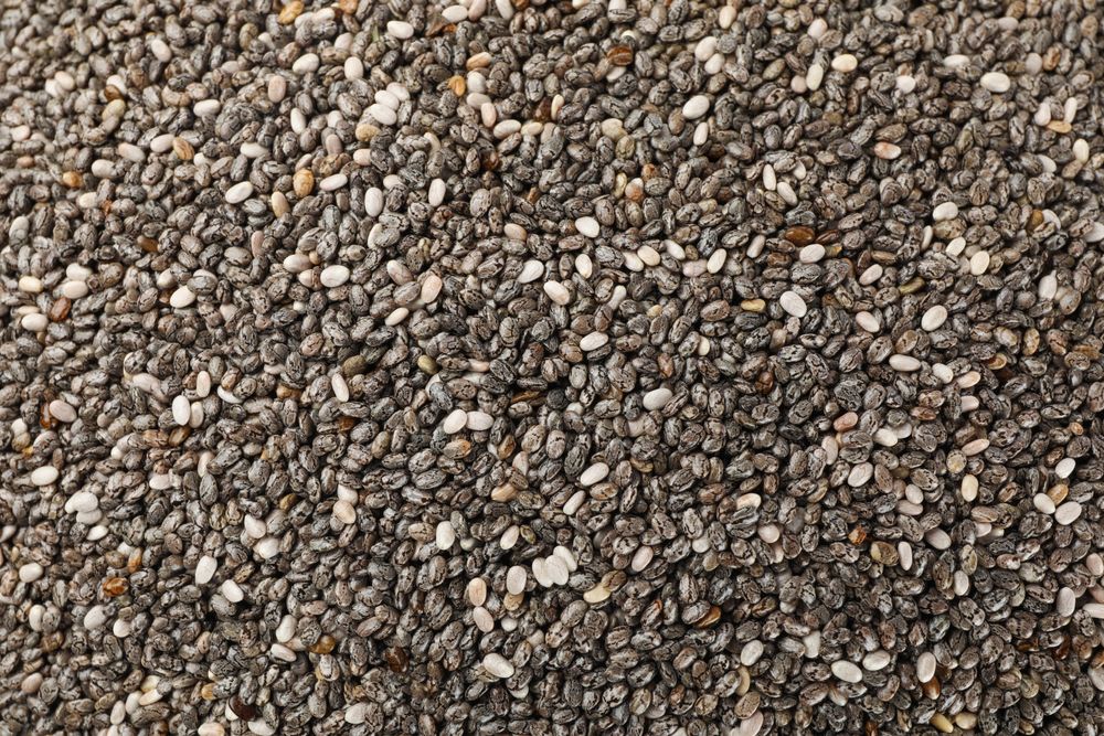 Chia seeds on whole background, close up