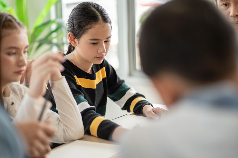 Attentive female student with notepad in class