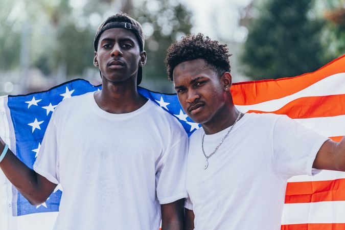 Black men in American Flag outside