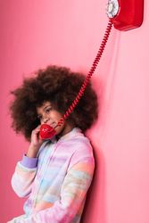 Black girl speaking on telephone in studio