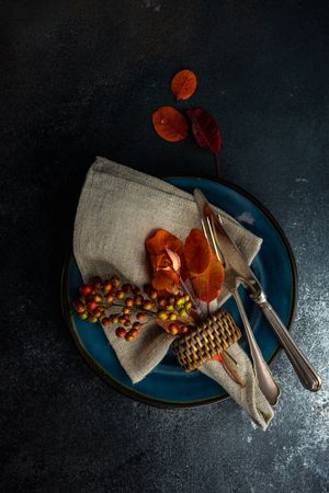 Top view of fall table setting with amber leaves