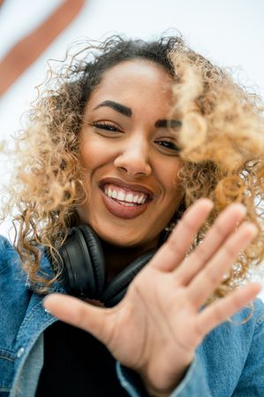 Cheerful ethnic woman with camera