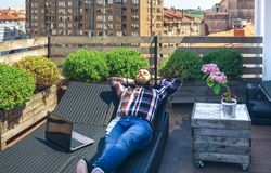 Businessman resting on lounger on terrace
