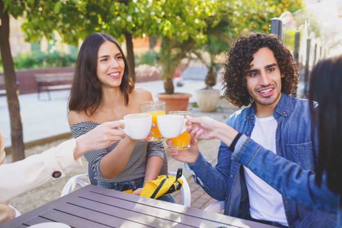 Man and woman sitting with their friends outside