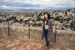 Cheerful woman visiting ancient city