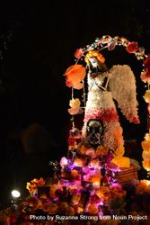 Paper Mache angel sculpture at atlar at Day of the Dead celebration at night 0KxVA5