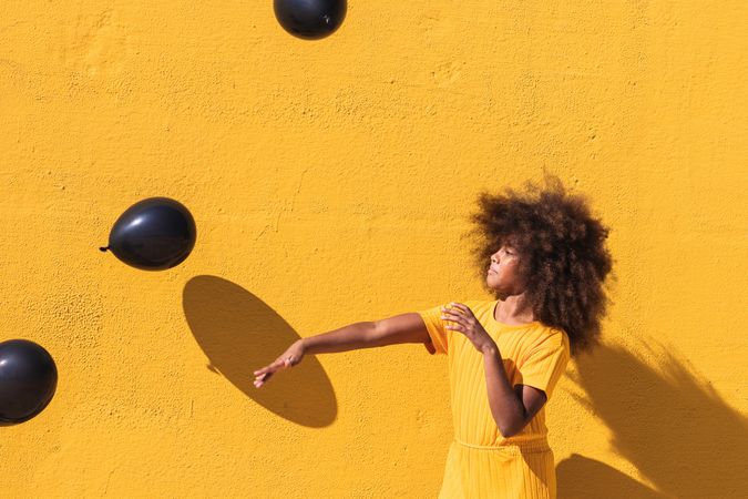 Happy Black girl playing with balloons