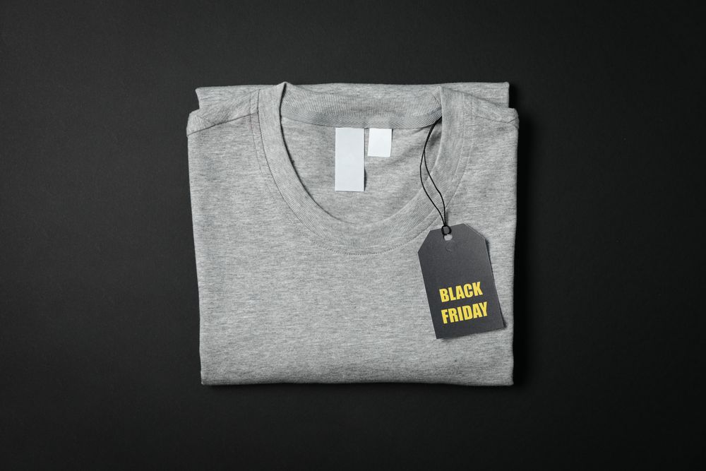 Folded gray t-shirt on dark background, space for text