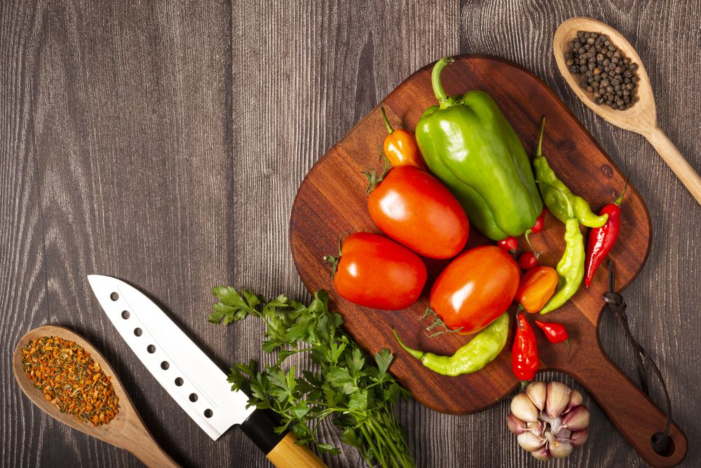 Ingredients for cooking with tomatoes, various peppers, garlic and green peppers.