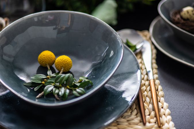 Elegant grey plates on placemat for spring themed table