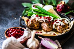 Meal of  abkhazura cutlets served with pomegranate seeds & onions with copy space