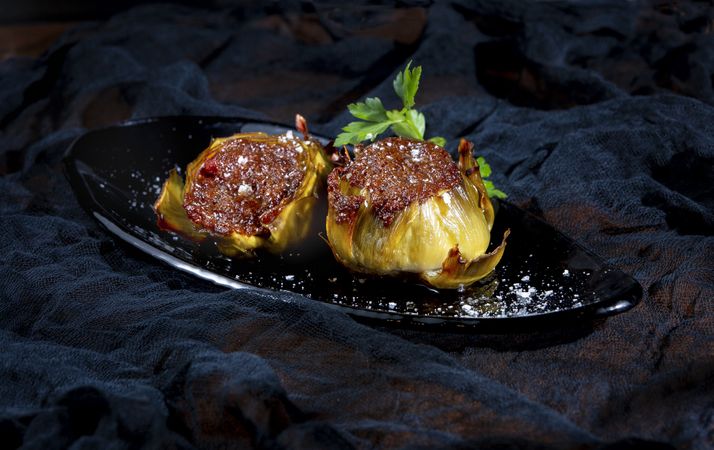 Delicious baked artichokes on plate