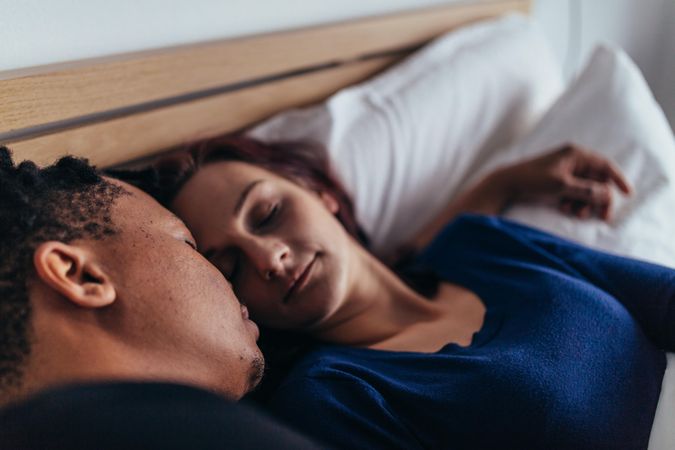 Close up of couple sleeping on bed
