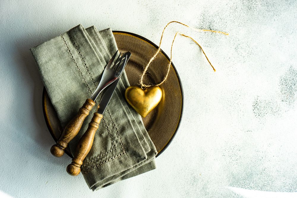 Top view of rustic table setting with heart decoration on marble table