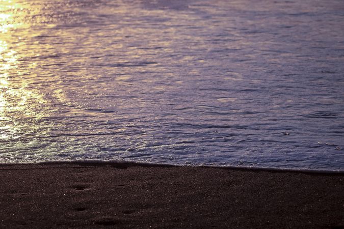 Ocean and sandy beach with late sun light