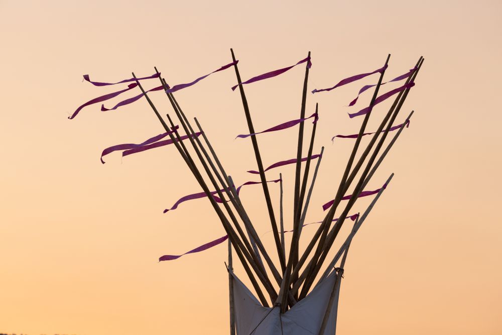 Montana, United States - August 17, 2022: Top of teepee blowing in the wind at sunset
