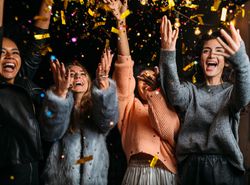 Outdoor shot of happy multi-ethnic female friends at birthday at night