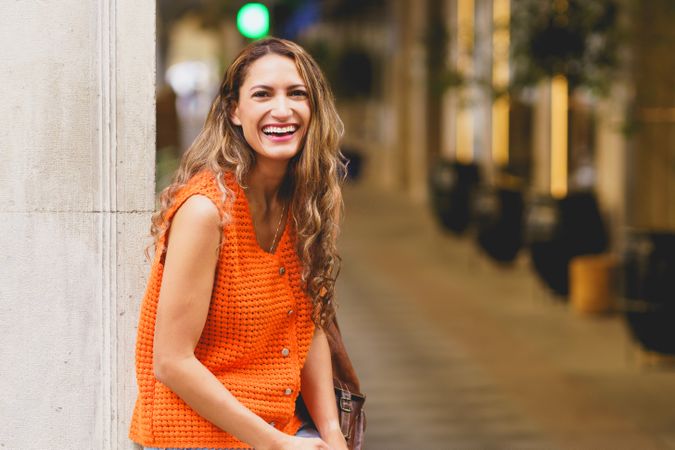 Woman laughing standing in street