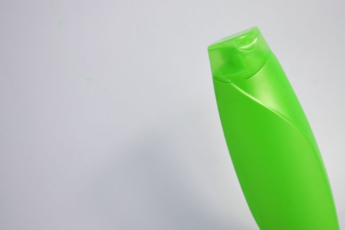 Green shampoo bottle with no labels in studio shoot