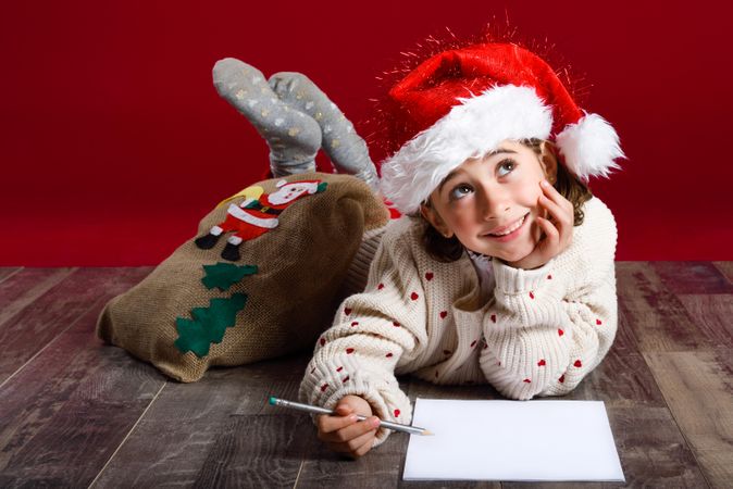 Cute child writing a letter to Santa at Christmas time